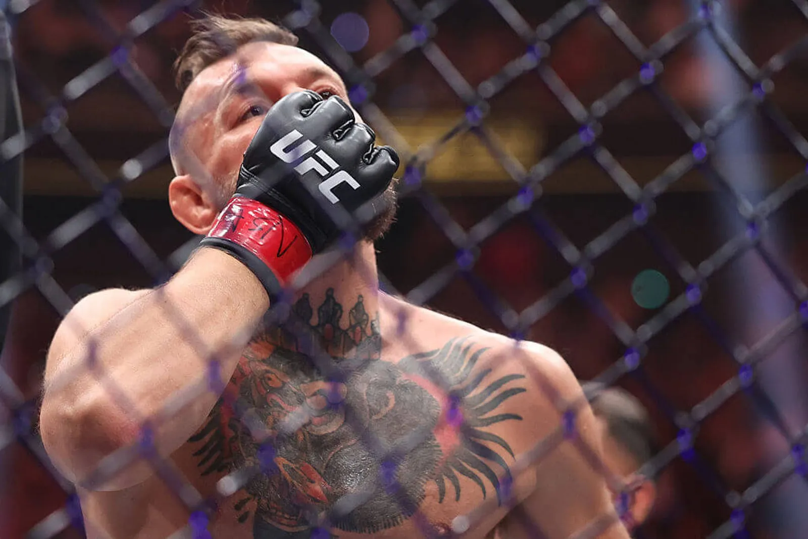 Conor McGregor reacts after sustaining a leg injury and losing in the first round of his fight against Max Holloway at UFC 329.