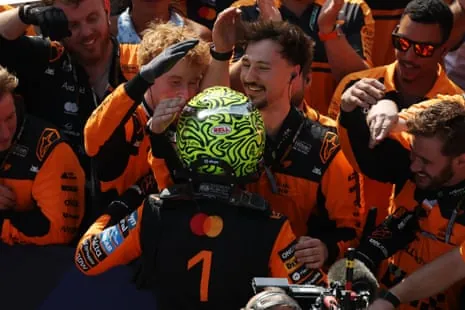 Race winner Lando Norris celebrates with his team in parc ferme.