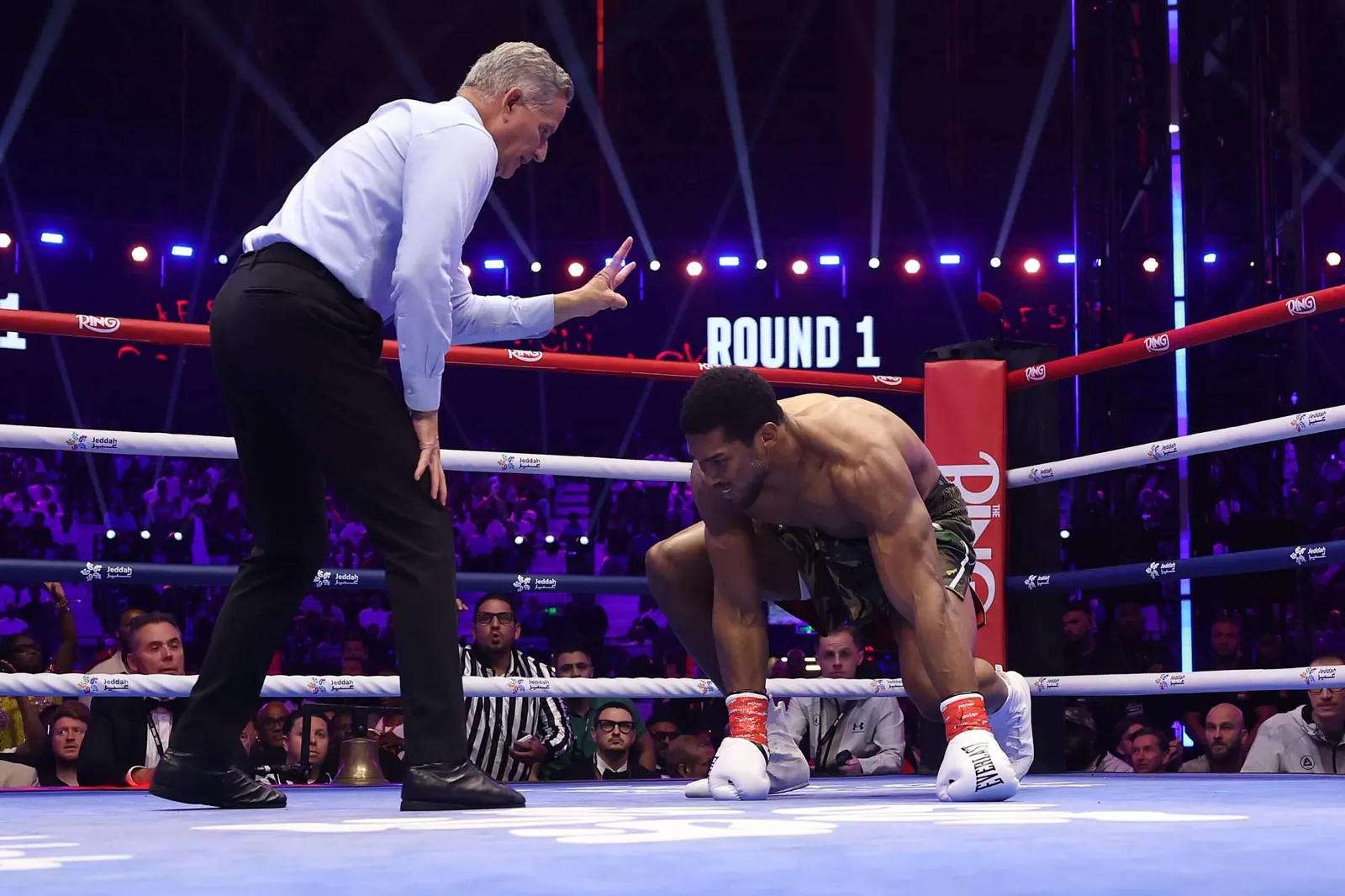 Anthony Joshua on the floor after being hit by Prenga