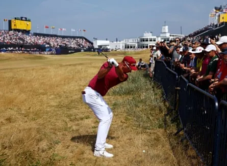 Lucas Herbert hits his approach on the 18th from the rough close to the spectators behind a fence