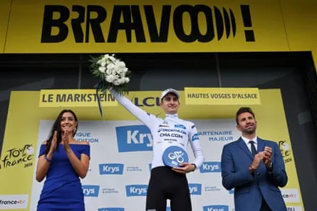 Paul Seixas celebrates on the podium with the best young rider’s white jersey after the 14th stage