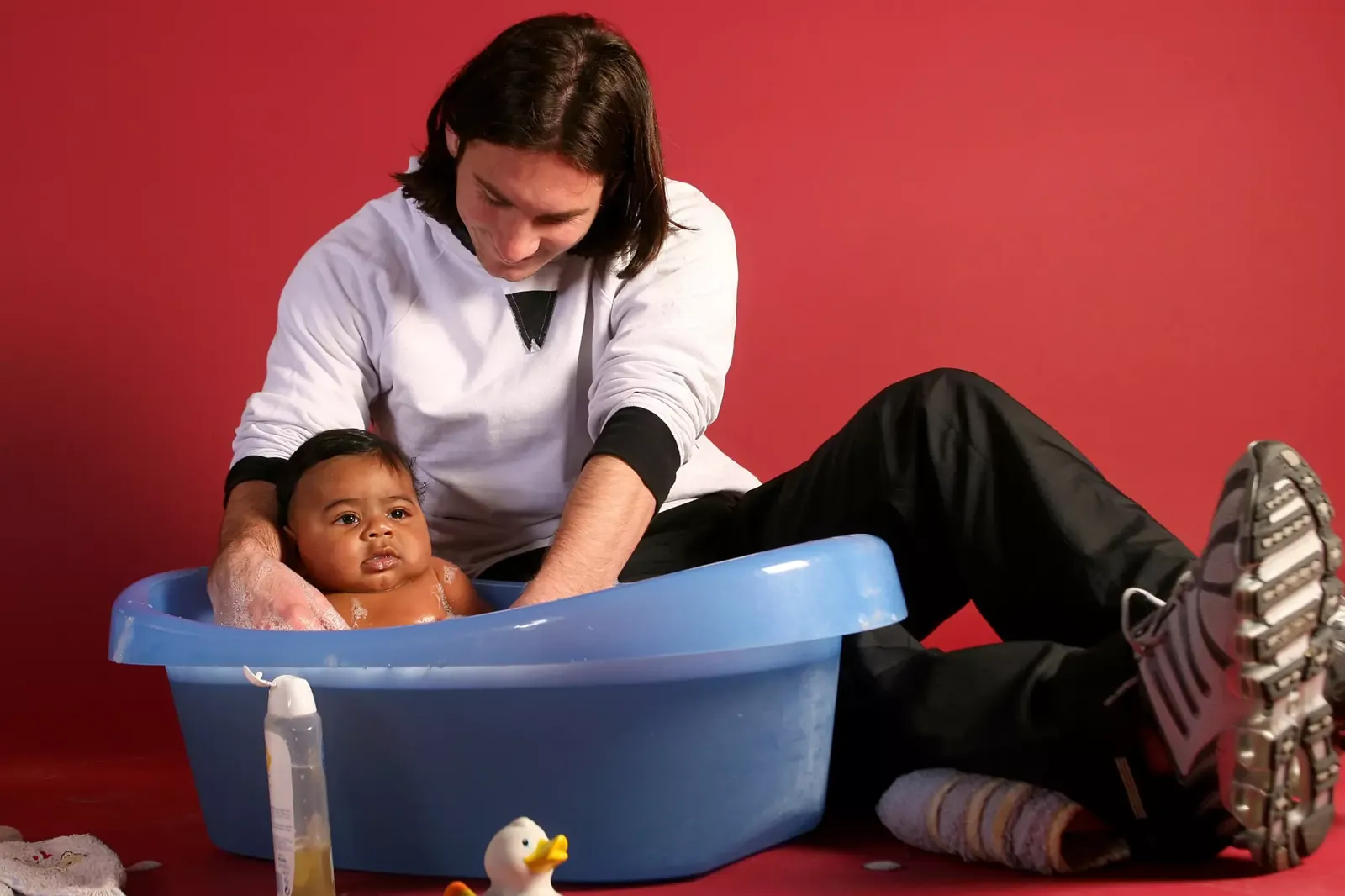 Lionel Messi, 20, helps to bathe Lamine Yamal, six months old, during a photo shoot in September 2007 in Barcelona.